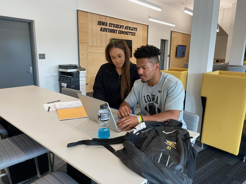 Tutor and student working together at a desk