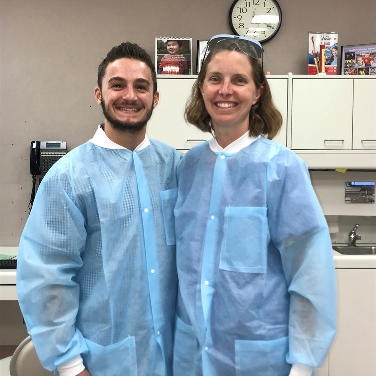 Two student athletes standing together in scrubs