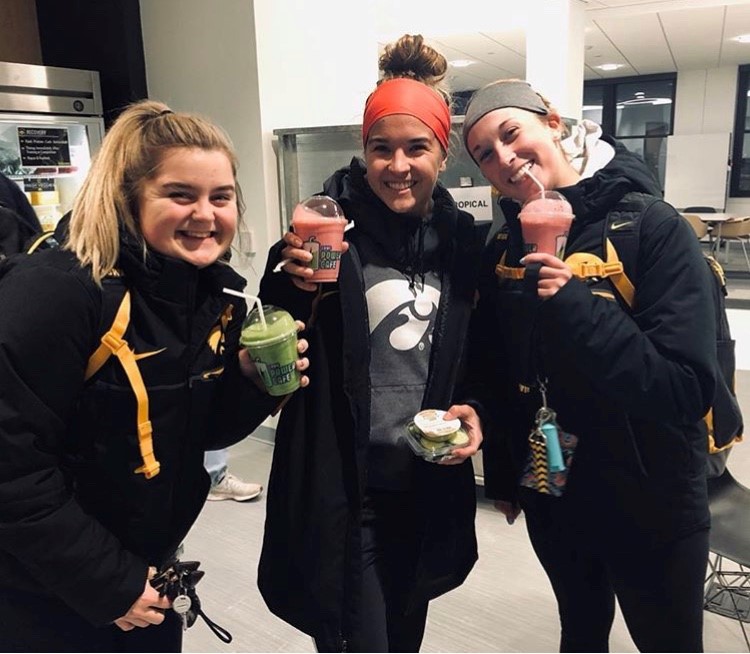 Three student-athletes enjoying smoothies