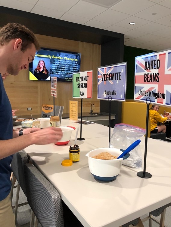 Student-athlete trying some international foods